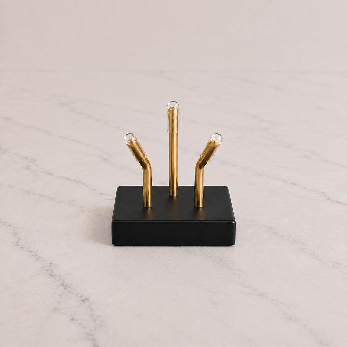 Black Sculptural Pedestal with brass mounting posts on marble