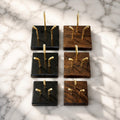 Full range of Sculptural Pedestals in Small, Medium, and Large sizes, shown in Black and Walnut finishes with brass mounting posts, on marble